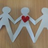 cut out of paper people holding hands