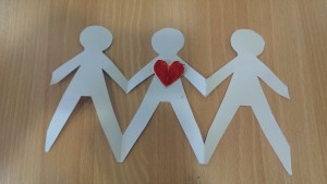 cut out of paper people holding hands