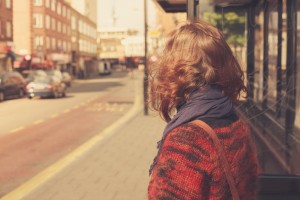 Young woman at bust stop