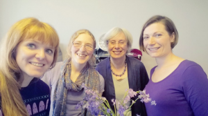 women wearing purple and smiling