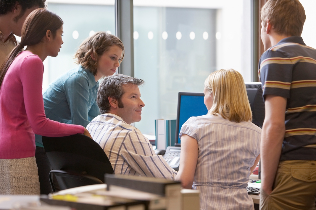 colleagues chatting at computer